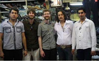Brothers Jared and Lucas Klassen (middle) with their Iranian shopkeeper hosts. Photo: courtesy Lucas Klassen
