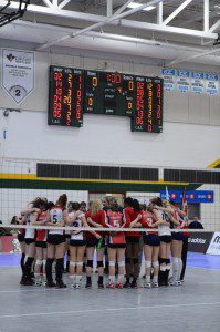 CBC Bearcats pray with an opposing team from Quebec after their volleyball game. Photo: Brin Dyer - Lakeland College