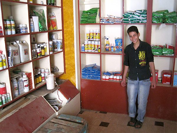 Bola Melad Ragheb, who limps because of polio, stands in the shop where he works after school, earning enough money to pay for his sister’s school costs. He credits an MCC Global Family education program with giving him the confidence to apply. MCC Photo: Isaac Friesen