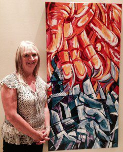 Winnipeg artist Faye Hall with her Human Rights Showcase painting "Fire & Ice" inspired by Dirk Willems.
