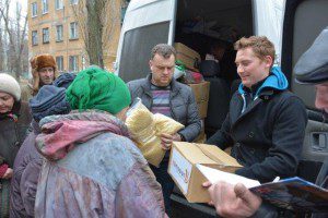 Lawrence Smith (r) and a Ukrainian church leader distributes relief supplies. 